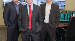 AISG President and CTO Levi Acs (front) is flanked by Arnold Koble, VP engineering (left) and Rocco Lipari, national operations director (right), inside the company&apos;s central monitoring facility.