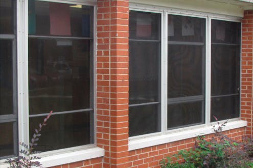 Security screens like the ones seen on these windows make it nearly impossible for an intruder to shoot their way into a school building.