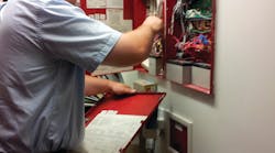 Service Manager Chip Wood, American Fire &amp; Security/The Security Girl, performs a fire alarm system inspection as part of the company&rsquo;s service contracts, of which some 85 percent of clients have opted into.