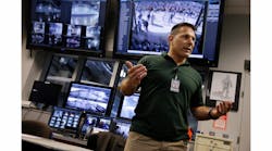 In this Oct. 15, 2014, photo, Daniel DeLorenzi, director of security and safety services at MetLife Stadium, stands near monitors for security cameras in the command center at the stadium in East Rutherford, N.J.