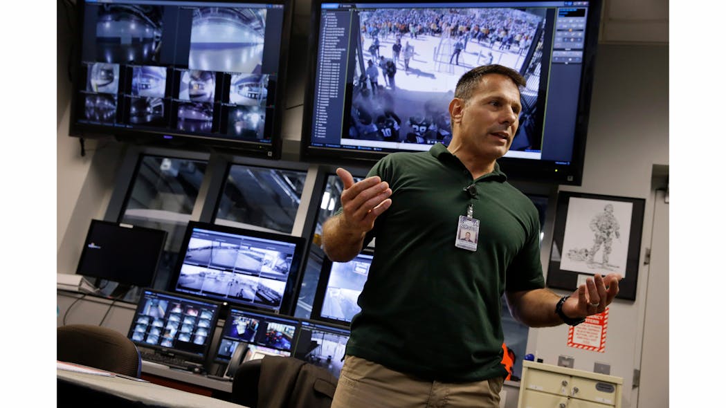 In this Oct. 15, 2014, photo, Daniel DeLorenzi, director of security and safety services at MetLife Stadium, stands near monitors for security cameras in the command center at the stadium in East Rutherford, N.J.