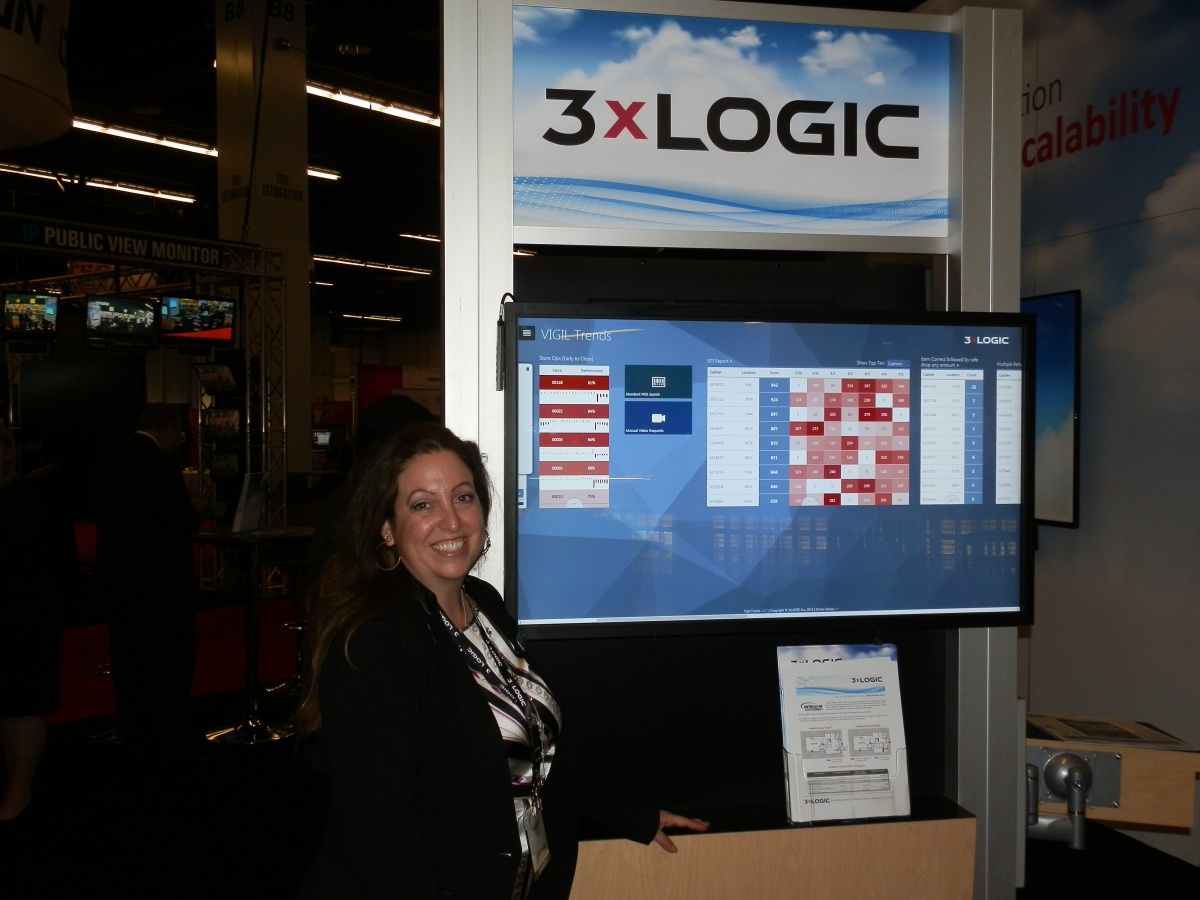 Wendi Burke, senior director of marketing for 3xLOGIC, stands in front of the company's booth at ASIS 2015.