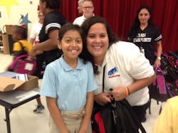 COPS Monitoring's Alejandra Hernandez with elementary school children at the kit build. COPS Monitoring's Alejandra Hernandez with elementary school children at the kit build.