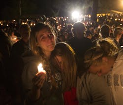 A group of young women console each other during a vigil on Oct. 1, 2015 in Roseburg, Ore. after a shooter opened fire at the Umpqua Community College, killing several. A group of young women console each other during a vigil on Oct. 1, 2015 in Roseburg, Ore. after a shooter opened fire at the Umpqua Community College, killing several.