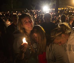 A group of young women console each other during a vigil on Oct. 1, 2015 in Roseburg, Ore. after a shooter opened fire at the Umpqua Community College, killing several.