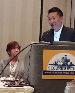 James Chong, president of Vidsys, accepted the Grand Platinum award for the top security project at the Secured Cities Conference. Project Manager Julie Stroup of the City of Houston Mayor&rsquo;s Office of Public Safety and Homeland Security, looks on.