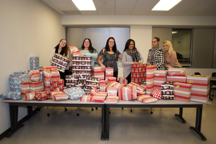 Alliance Security employees wrapping presents for needy children during December