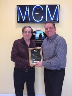 Dan Artman of Sielox presents Rich McMillan of MCM Integrated Systems with the company&rsquo;s 17th consecutive Business Partner of the Year Award.