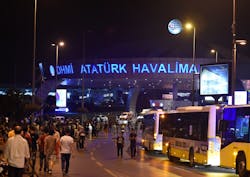 People stand at the entrance to Ataturk International Airport in Istanbul on Wednesday, June 29, 2016. A suicide attack killed 36 people at the airport Tuesday night.
