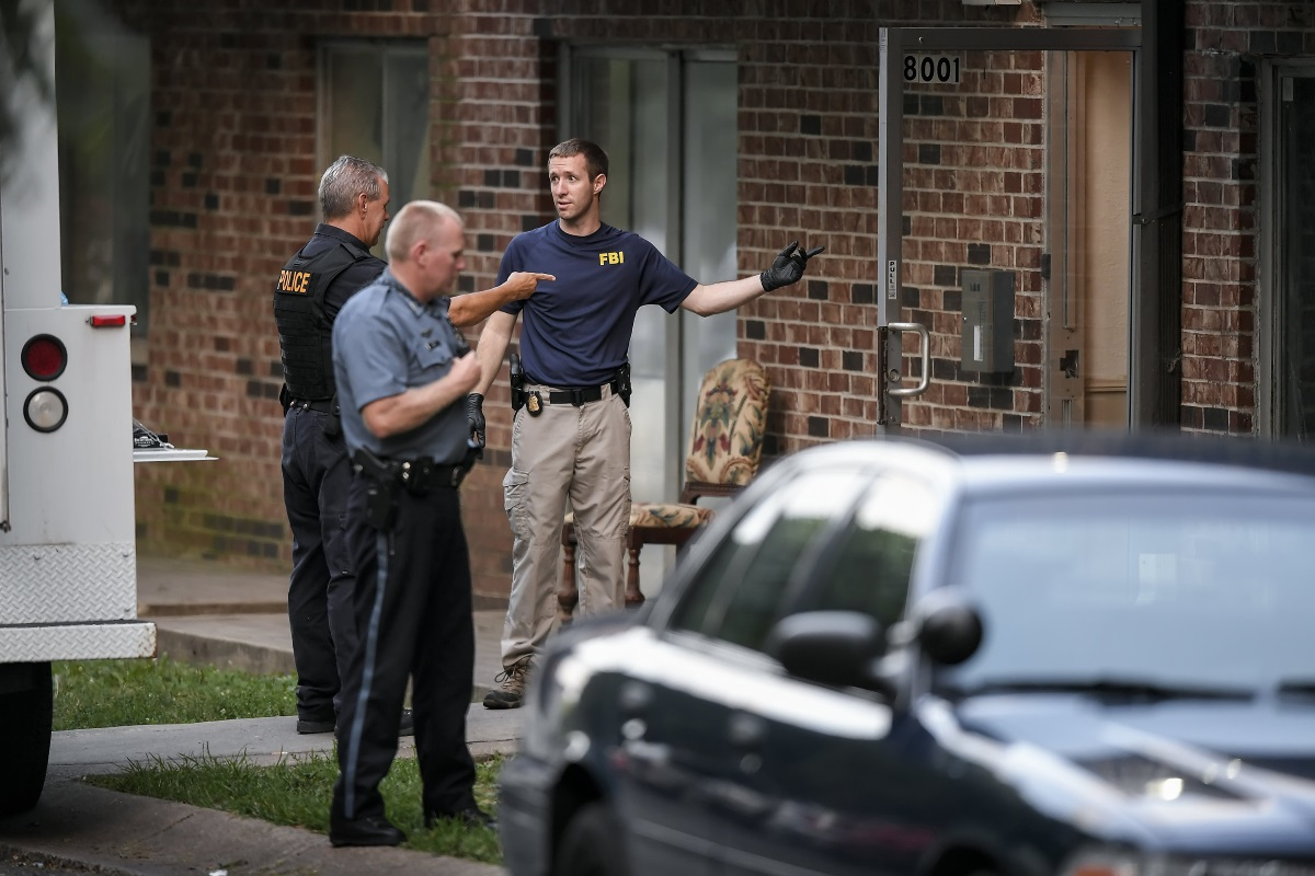 FBI evidence recovery team members search inside the Waldo Heights apartment complex at 8101 Campbell Street in Kansas City, Mo., on Sunday, July 17, 2016, in connection to the shooting in Baton Rouge, La., by accused shooter Gavin Eugene Long, 29, of Kansas City, which killed three police officers and wounded three more officers.