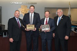 SIAC Executive Director Stan Martin and Sheriff Mark Wasylyshyn on behalf of the National Sheriffs&rsquo; Association presented the award to Sheriff Livingston and Bay Alarm&rsquo;s Matt Westphal.