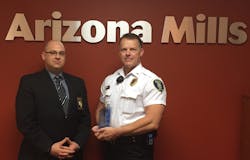 Arizona Mills Mall Security Professional Kevin Soulages receives the Tom Cernock Award from Account Manager Mark Lo Schiavo.