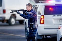 Police go through the parking lot of Excel Industries in Hesston, Kan., where a gunman reportedly killed up to seven people and injured many others on Thursday, Feb. 25, 2016.