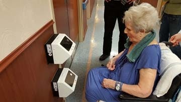 A resident at Brevillier Village uses the IOM Access Control reader.