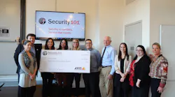 Nathan Zautcke (fifth from right), owner of Security 101's Detroit franchise, and his team present a check for the installation of an Axis video surveillance system and recorder to HOPE, a nonprofit Detroit civil and human rights organization, as part of Security 101’s 5th Annual Gift of Security program.