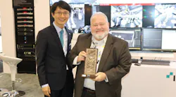 Southcomm Security Media Editorial Director Steve Lasky accepts an award honoring the company's media support from IDIS president Dr. Albert Ryu.