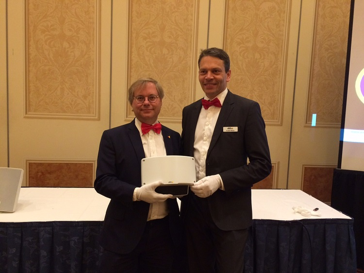 Martin Gren, left, and Fredrik Nilsson, right, hold Axis' new IP radar detector at ISC West 2017.