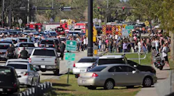 Students are brought across Coral Springs Drive from the campus of Marjory Stoneman Douglas High School in Parkland, Fla., after a shooting on Wednesday, Feb. 14, 2018.