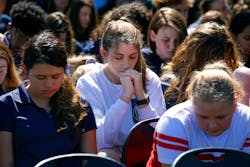 People gather for a memorial at Parkridge Church in Coral Springs, Fla. on Thursday, Feb. 15, 2018, one day after the deadly shooting at Marjory Stoneman Douglas High School in Parkland, Fla.
