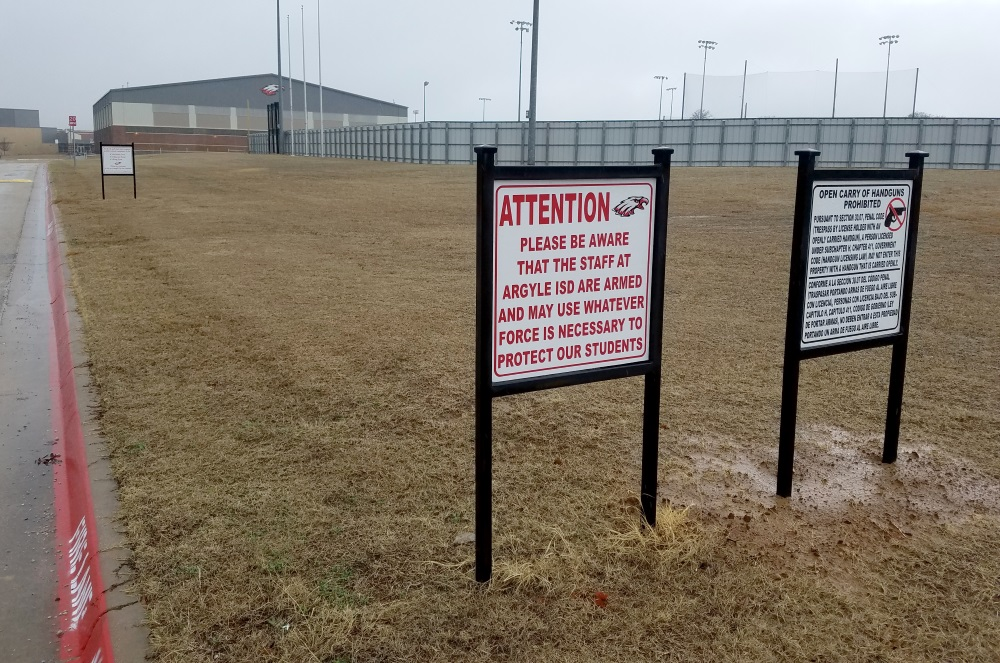 Signs alert those approaching Argyle High School in Argyle, Texas, that staff are armed. Security consultant Patrick Fiel, who formerly served as Executive Director of Security for the Washington, D.C. Public School System, believes arming teachers is not the best approach to mitigating active shooter threats in our nation's schools.