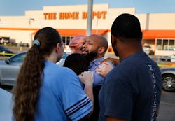 Home Depot employees comfort one another outside the Dallas store after two officers and a civilian were shot by a man on Tuesday, April 24, 2018. Home Depot employees comfort one another outside the Dallas store after two officers and a civilian were shot by a man on Tuesday, April 24, 2018.