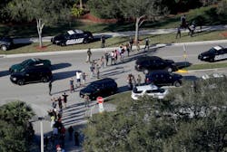 Students are evacuated by police out of Stoneman Douglas High School in Parkland, Fla., after a shooting on Wednesday, Feb. 14, 2018. Students are evacuated by police out of Stoneman Douglas High School in Parkland, Fla., after a shooting on Wednesday, Feb. 14, 2018.