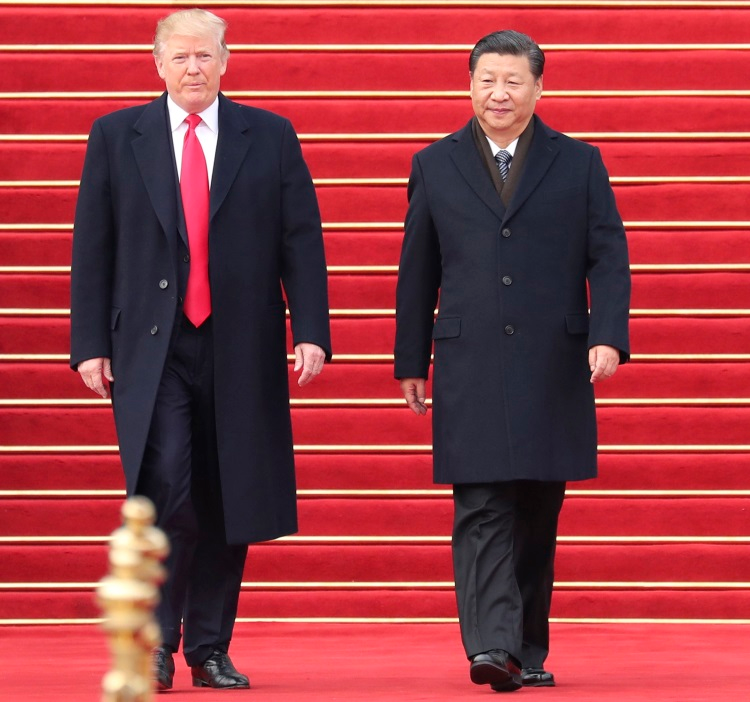 Chinese President Xi Jinping, right, welcomes President Donald Trump at the square outside the east gate of the Great Hall of the People in Beijing on Nov. 9, 2017.
