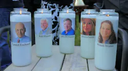 Candles honoring Gerald Fischman, Rob Hiassen, John McNamara, Rebecca Smith, and Wendi Winters flicker as the sun sets during a candlelight vigil on Friday, June 29, 2018, at Annapolis Mall for the five Capital Gazette employees slain during a shooting spree in their newsroom.