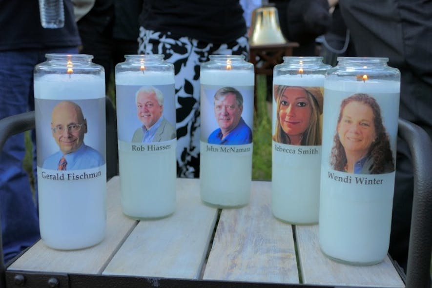 Candles honoring Gerald Fischman, Rob Hiassen, John McNamara, Rebecca Smith, and Wendi Winters flicker as the sun sets during a candlelight vigil on Friday, June 29, 2018, at Annapolis Mall for the five Capital Gazette employees slain during a shooting spree in their newsroom.