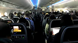 Main cabin passengers pass the time aboard American Airlines flight 2331, a Boeing 787-800 Dreamliner, an route from Chicago O'Hare International Airport to Dallas/Fort Worth International Airport, on March 5, 2018.