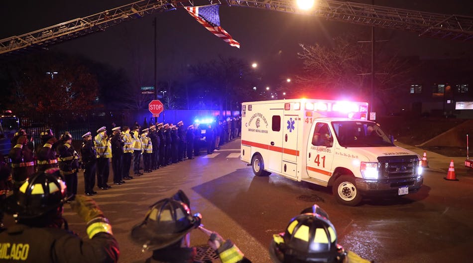 Chicago firefighters and police salute the ambulance carrying the body of Officer Samuel Jimenez outside of the Medical Examiners office at Leavitt and West Harrison streets in Chicago on Nov. 19, 2018. Jimenez was killed at Mercy Hospital today.