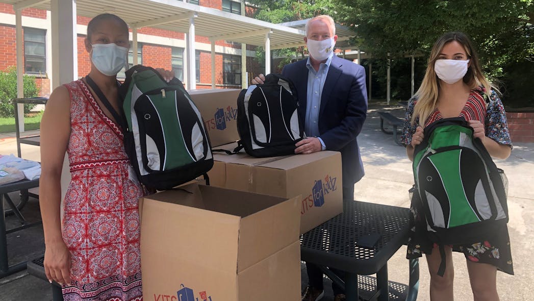 Sage Integration&rsquo;s John Nemerofsky and Olivia Crump deliver back-to-school backpacks filled by Atlanta office employees High Point Elementary School principal Danielle Miller (left) as part of an annual Mission 500 project.