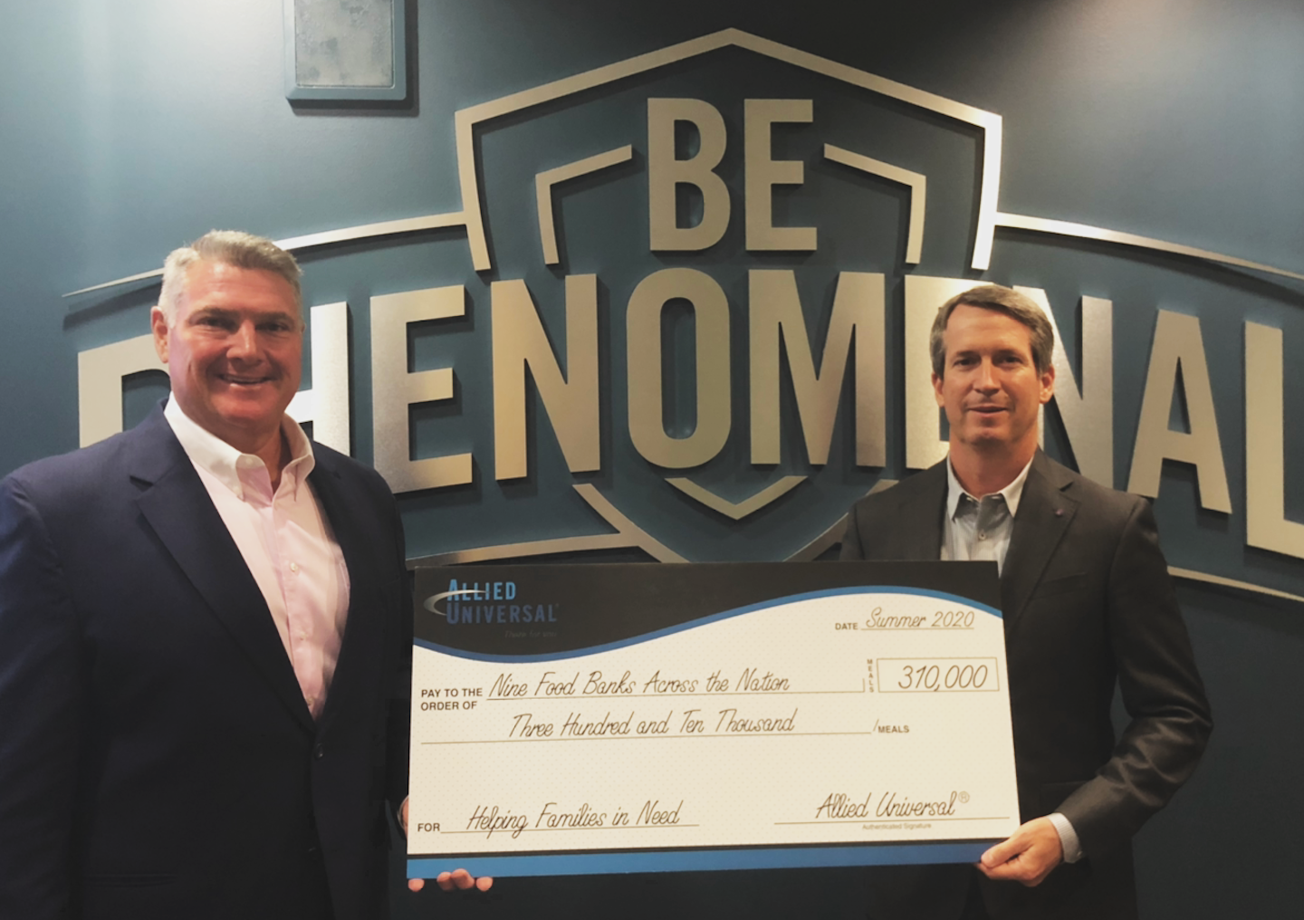 Allied Universal's Steve Jones and Don Tefft with a presentation for nine food banks across the United States.