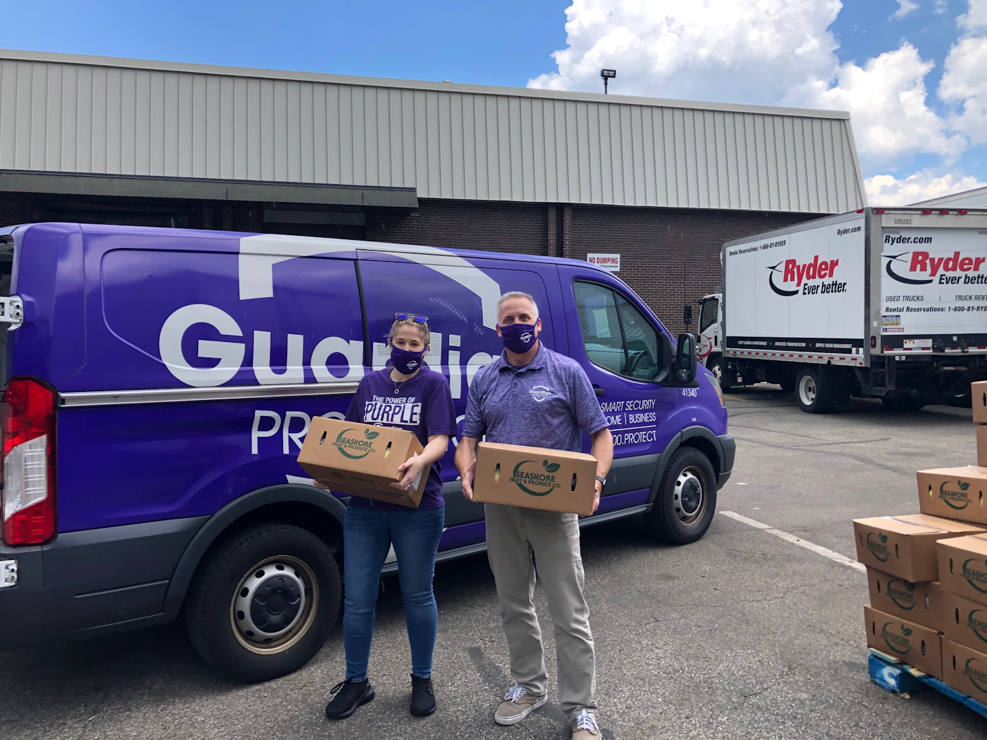 Guardian Protection volunteers Caroline Erny and Kevin Bish load the Guardian van with fresh food for the hungry.