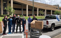 Brittany Wiggins (left) and other Baptist Medical Center South representatives accept meals from Vision Technologies CEO Barry Komisar (third from left) and Trae Padilla (second from right). Brittany Wiggins (left) and other Baptist Medical Center South representatives accept meals from Vision Technologies CEO Barry Komisar (third from left) and Trae Padilla (second from right).
