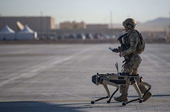 Tech. Sgt. John Rodiguez, 321st Contingency Response Squadron security team, patrols with a Ghost Robotics Vision 60 prototype at a simulated austere base during the Advanced Battle Management System exercise on Nellis Air Force Base, Nev., Sept. 3, 2020.
