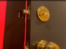 A closer look at the pivoting &apos;bucket&apos; that enables the door to be opened and closed remotely with the deadbolt extended.
