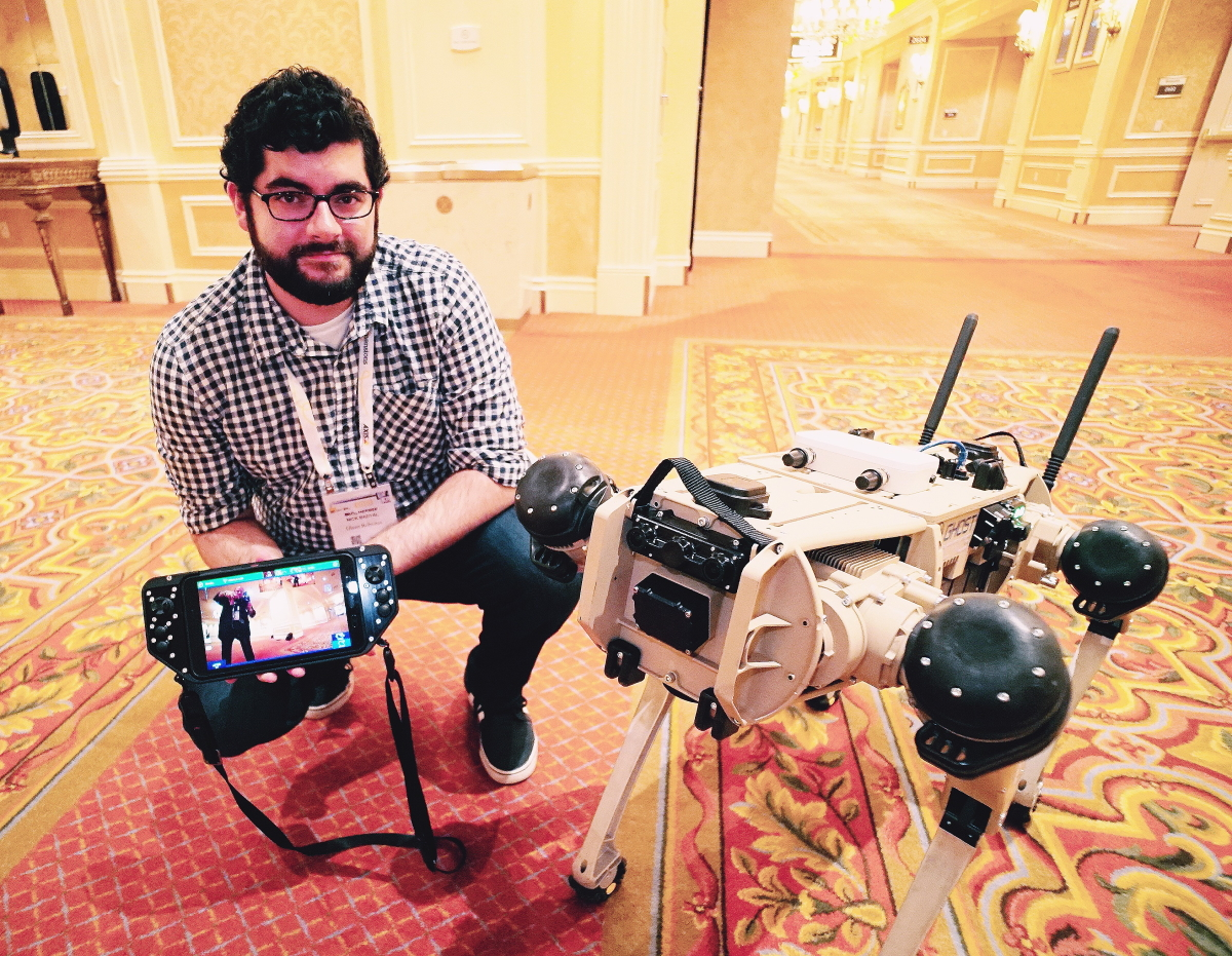 Nick Badyal, software engineer for Ghost Robotics, shows off the company's Vision 60 quad-legged autonomous unmanned ground vehicle (Q-UGV) at ISC West 2021.