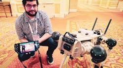 Nick Badyal, software engineer for Ghost Robotics, shows off the company&apos;s Vision 60 quad-legged autonomous unmanned ground vehicle (Q-UGV) at ISC West 2021.