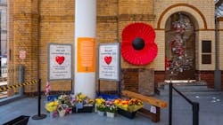 Manchester, UK - May 18 2018: Flowers are brought to a makeshift memorial at Manchester Victoria station on the one-year anniversary of the attack on Manchester Arena where 22 people lost their lives. Manchester, UK - May 18 2018: Flowers are brought to a makeshift memorial at Manchester Victoria station on the one-year anniversary of the attack on Manchester Arena where 22 people lost their lives.