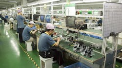 Workers test video surveillance components inside a manufacturing facility in Shenzhen, China, in April 2010. Legislation recently passed by the U.S. House would bar the FCC from reviewing or granting new equipment authorizations to companies on the agency&apos;s &apos;Covered List.&apos;