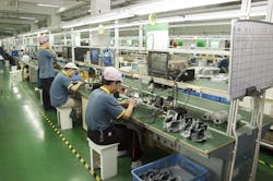 Workers test video surveillance components inside a manufacturing facility in Shenzhen, China, in April 2010. Legislation recently passed by the U.S. House would bar the FCC from reviewing or granting new equipment authorizations to companies on the agency&apos;s &apos;Covered List.&apos;