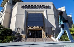 A security guard patrols the front entrance of a Los Angeles Nordstrom after an organized group of thieves attempted a smash-and-grab robbery last week.