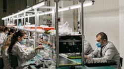 Workers assemble products from Ajax Systems at a Ukrainian facility. Workers assemble products from Ajax Systems at a Ukrainian facility.