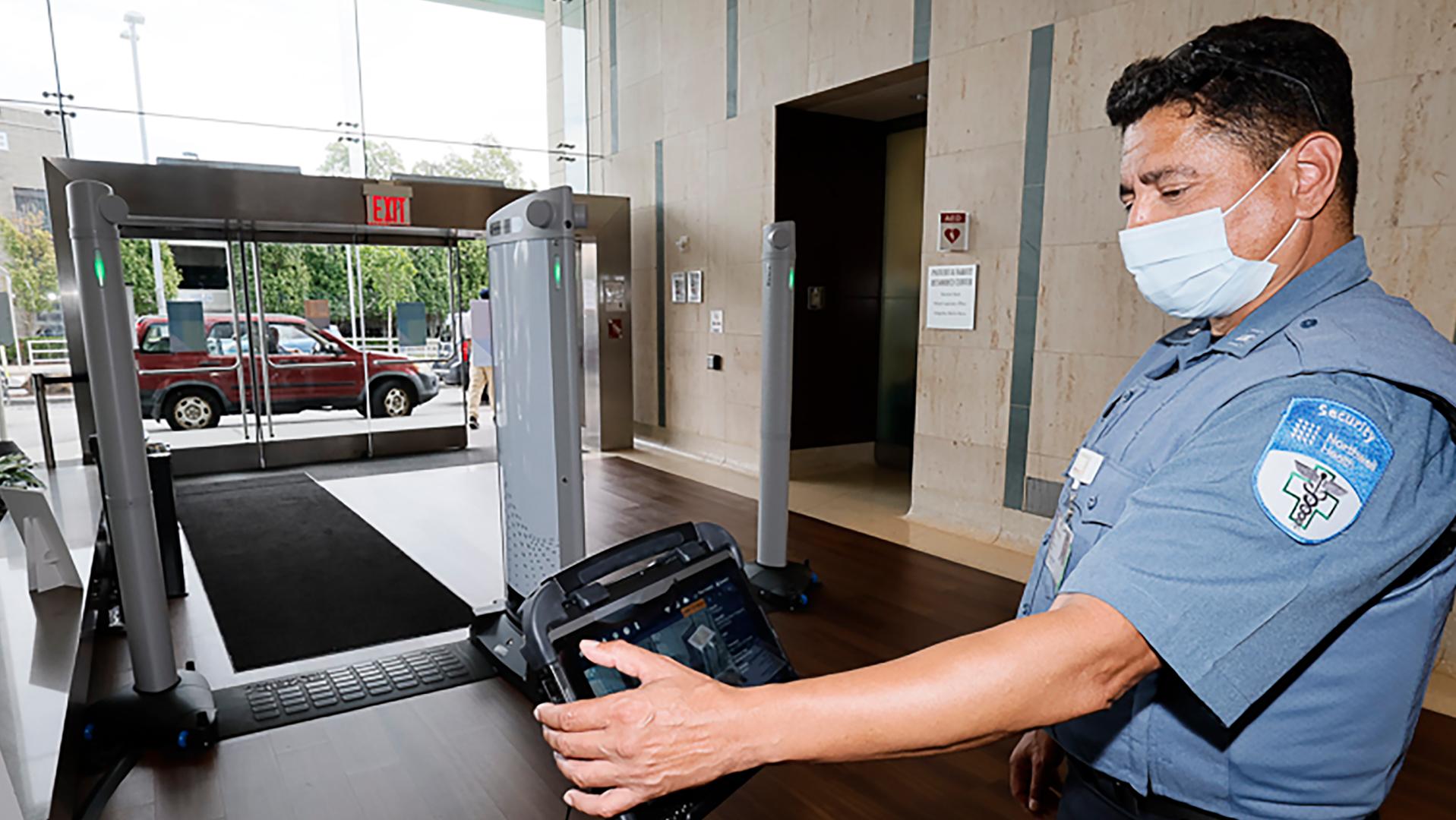 A Northwell Health security officer monitors Evolv Express at the entrance to Long Island Jewish Medical Center in New Hyde Park.
