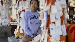 Stephanie Diaz, 16, a Highland Park High School junior, sits among messages left at the downtown memorial on Aug. 16, 2022, after the Fourth of July parade shooting.