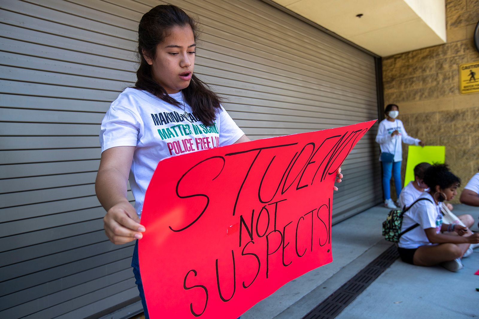 At a protest outside LAUSD headquarters in June, a student holds a sign she made with a friend as she and other students called for an end to police officers on campuses.