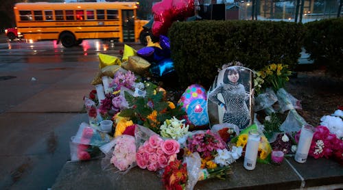 A photo of Alexzandria Bell, 15, rests at the scene of a growing floral memorial to the victims of Monday&apos;s school shooting at Central Visual &amp; Performing Arts High School, on Tuesday, Oct. 25, 2022. Bell and teacher Jean Kuczka were killed, along with gunman Orlando Harris, in Monday&apos;s shooting.