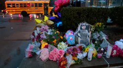 A photo of Alexzandria Bell, 15, rests at the scene of a growing floral memorial to the victims of Monday's school shooting at Central Visual & Performing Arts High School, on Tuesday, Oct. 25, 2022. Bell and teacher Jean Kuczka were killed, along with gunman Orlando Harris, in Monday's shooting.