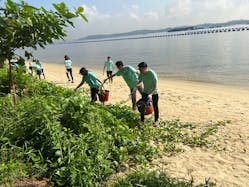 Convergint employees work to clean up a local beach as part of the annual Convergint Social Responsibility Day.